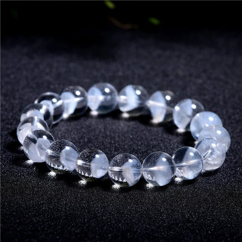 Women's white crystal ghost pyramid bracelet with ruyi symbol on wrist, showing adjustable bead sizes.