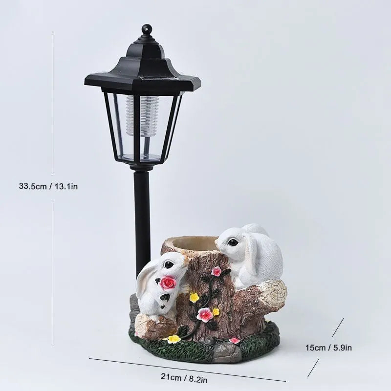 Solar hexagonal garden lamp with decorative resin figurine on plastic base for outdoor pathway lighting