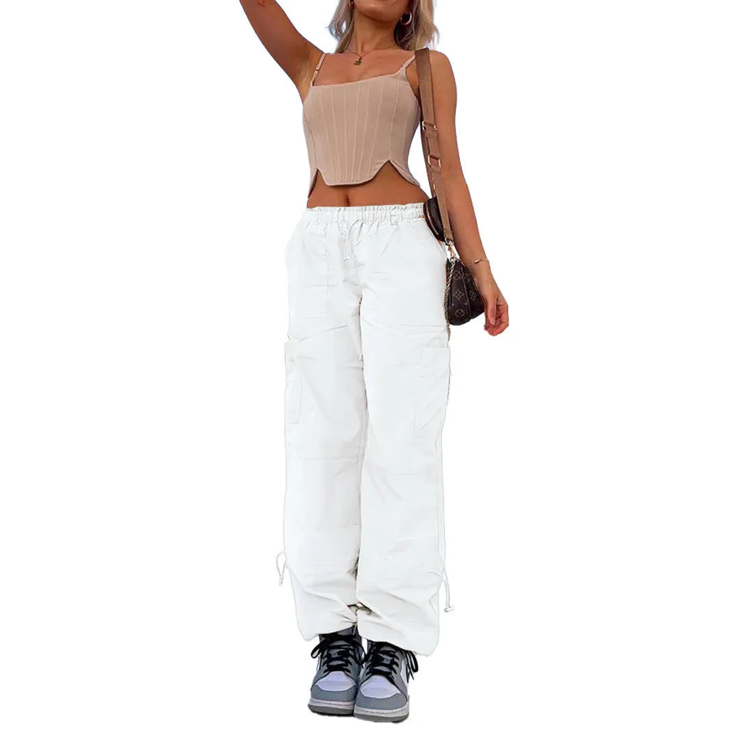 Man wearing loose grey straight-leg cargo casual pants with multiple pockets.