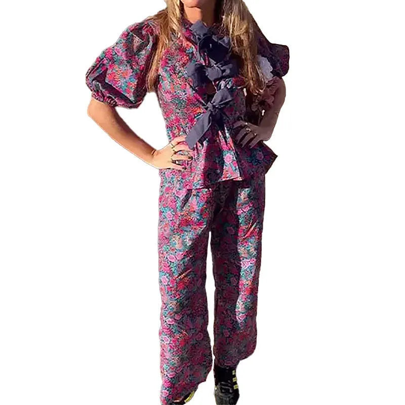 Floral print trousers suit with tie-neck blouse featuring puff sleeves and matching trousers