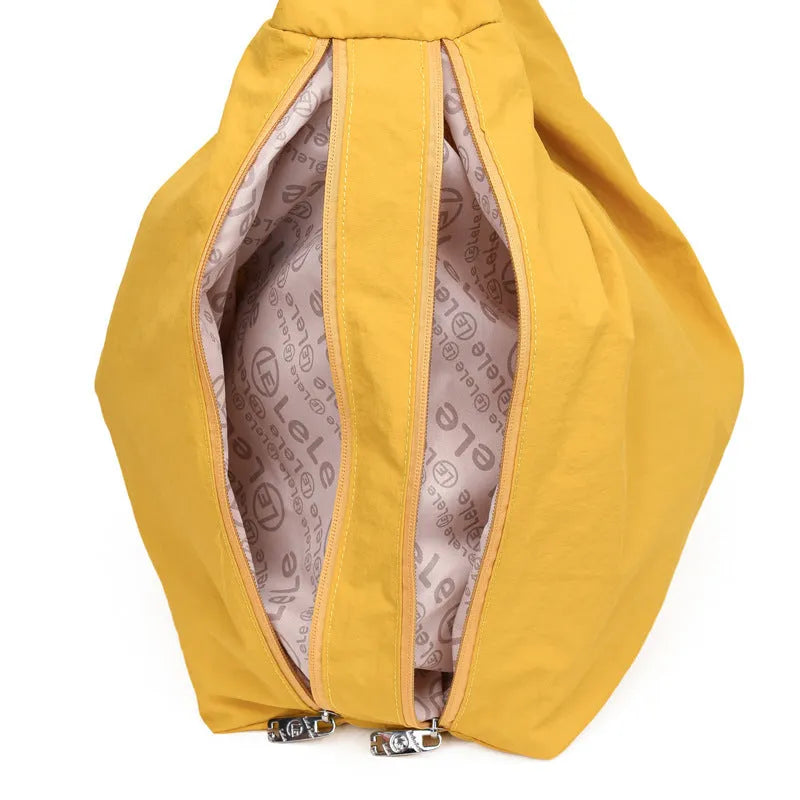 Nylon underarm bag with heart shape design in four colour options showing large capacity interior
