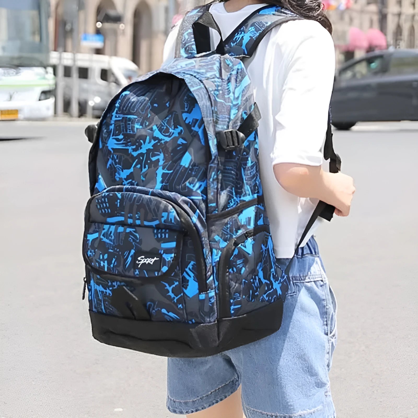 Classic large blue nylon backpack with multiple compartments shown from the front.