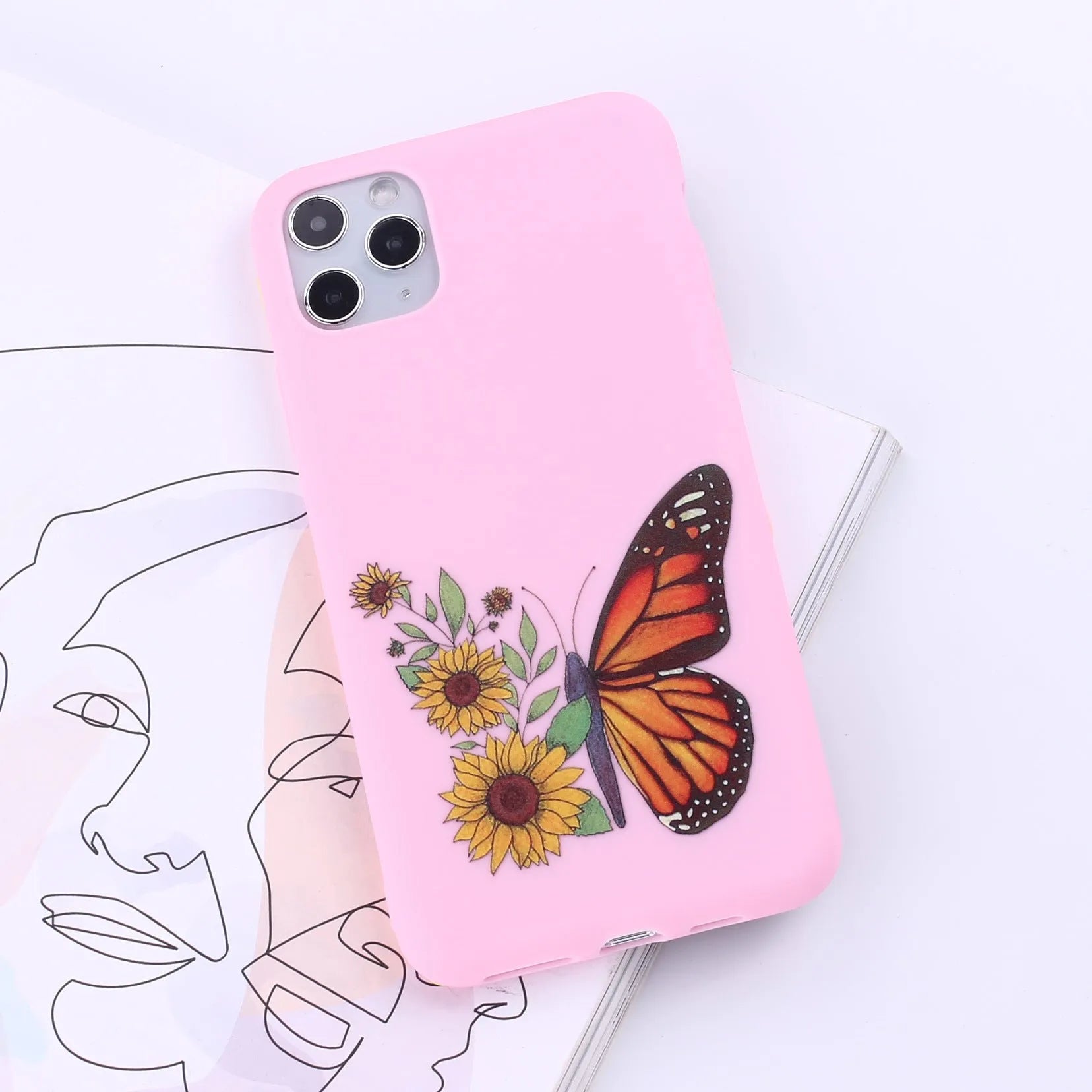 Slim TPU mobile phone case for iPhone on a table, showing one of 14 available colour options.