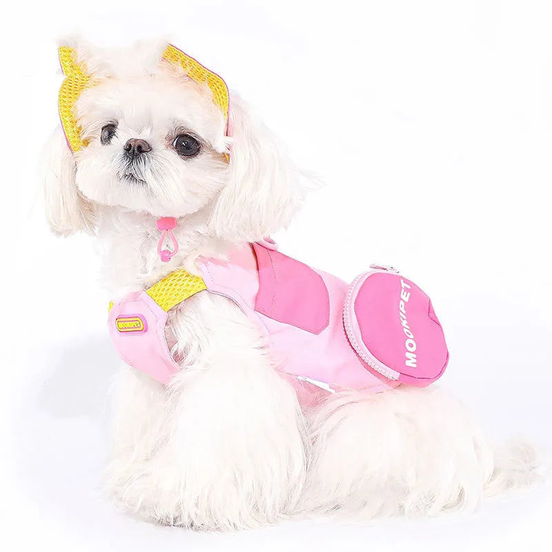 Pink adjustable traction vest on a small dog, showing the fit and fastening.