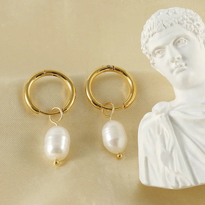 Gold geometric women's earrings made from stainless steel with a central pearl and titanium posts.