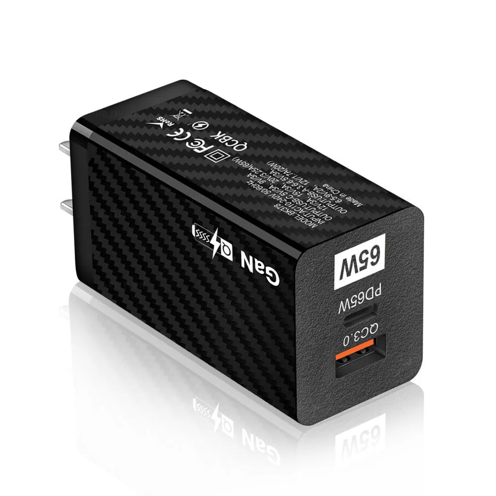 White gallium nitride GaN 65W laptop charger with USB-C port shown next to EU, UK, and US plug options