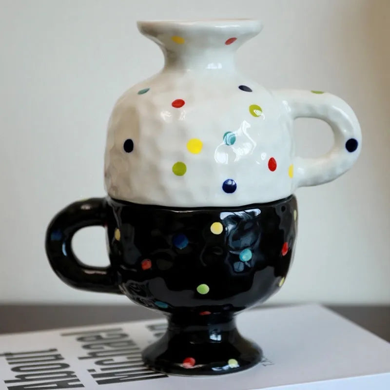 Hand-pinched irregular shaped ceramic mug in a solid colour on a table.