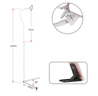 Black bedside mobile phone bracket with universal holder attached to bed frame for hands-free viewing