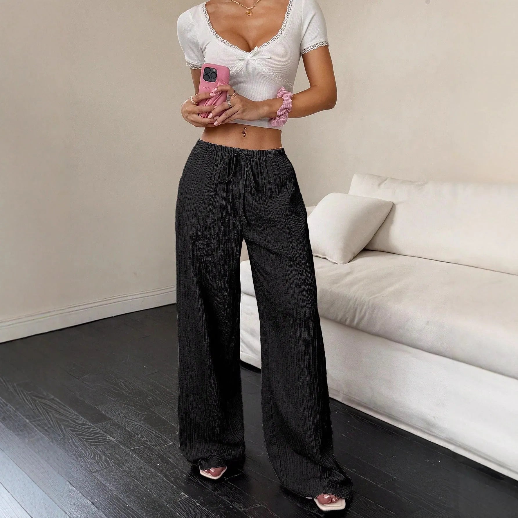 Women's black wide-leg trousers with lace-up waist detailing and adjustable ties