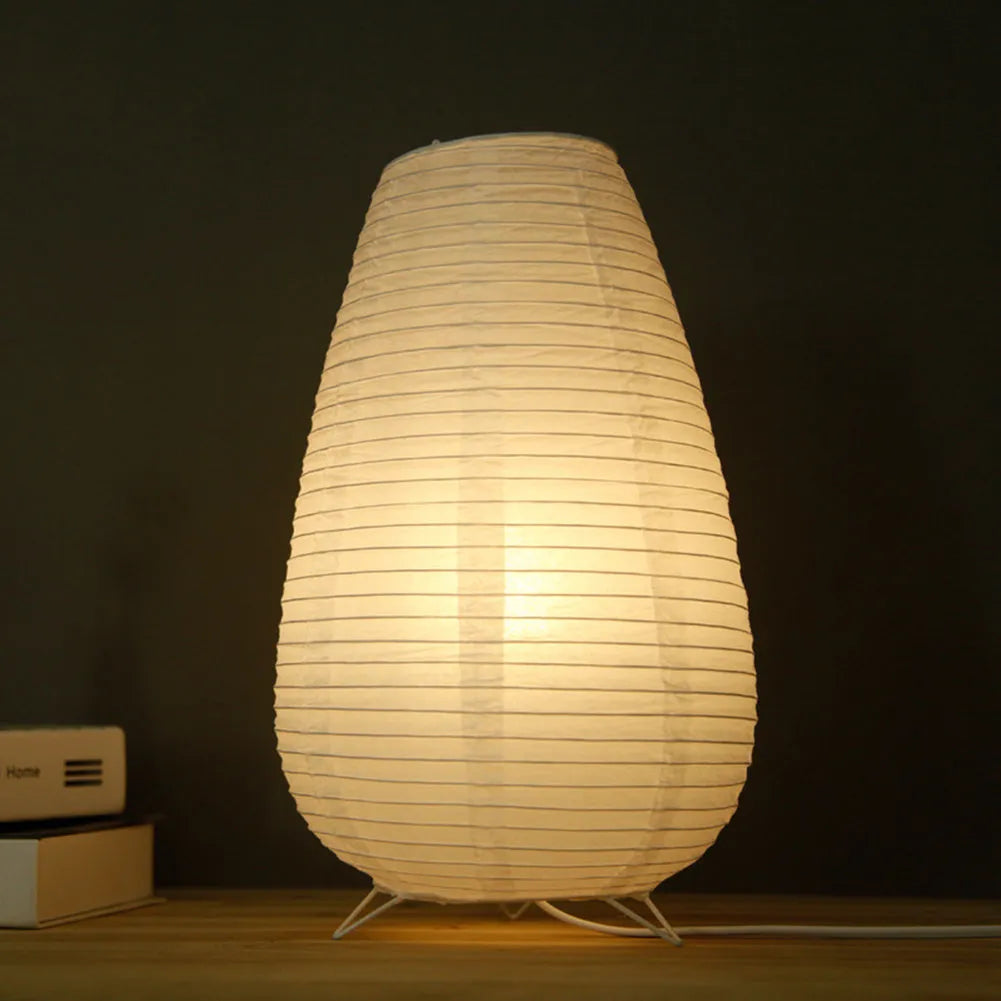 Small white table lamp with rice paper shade on bedside table, circular shape, traditional handwork