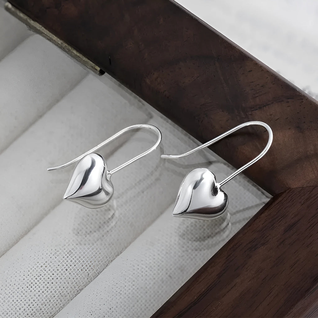 Three-dimensional glossy heart-shaped earrings in silver colour made from copper with white gold finish, Korean style for women