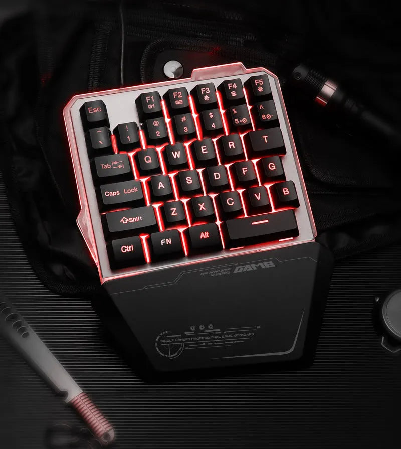 Black robotic one-handed G40 keyboard with RGB backlit keys on a desk.