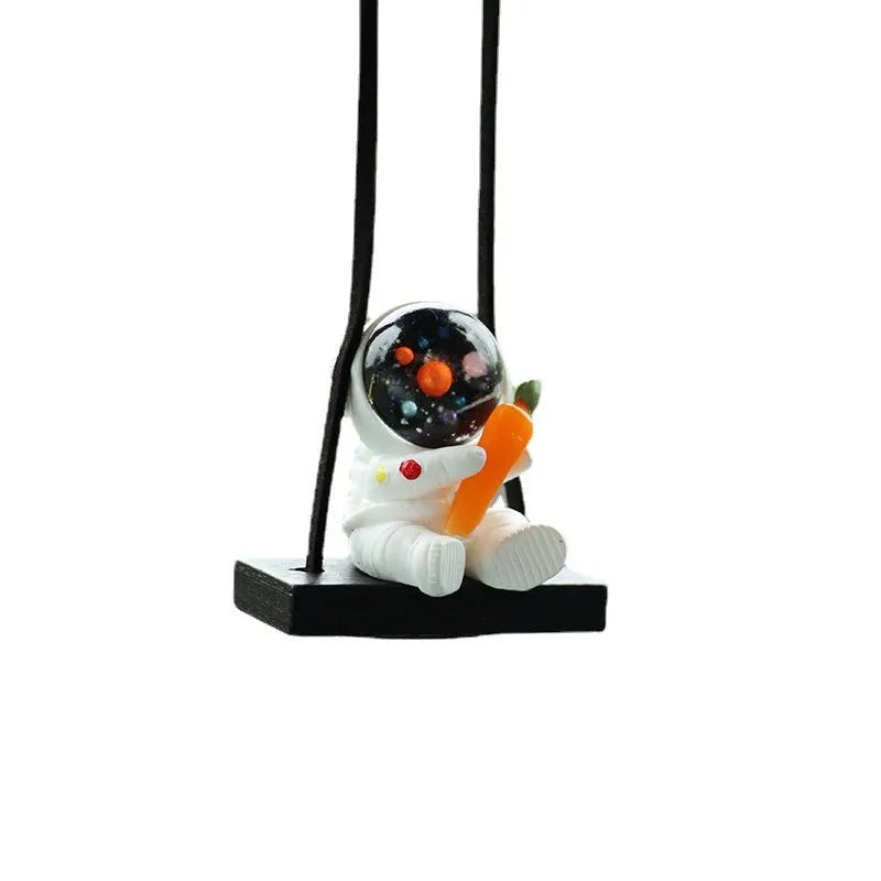 Resin astronaut car pendant in one of five cartoon colour designs