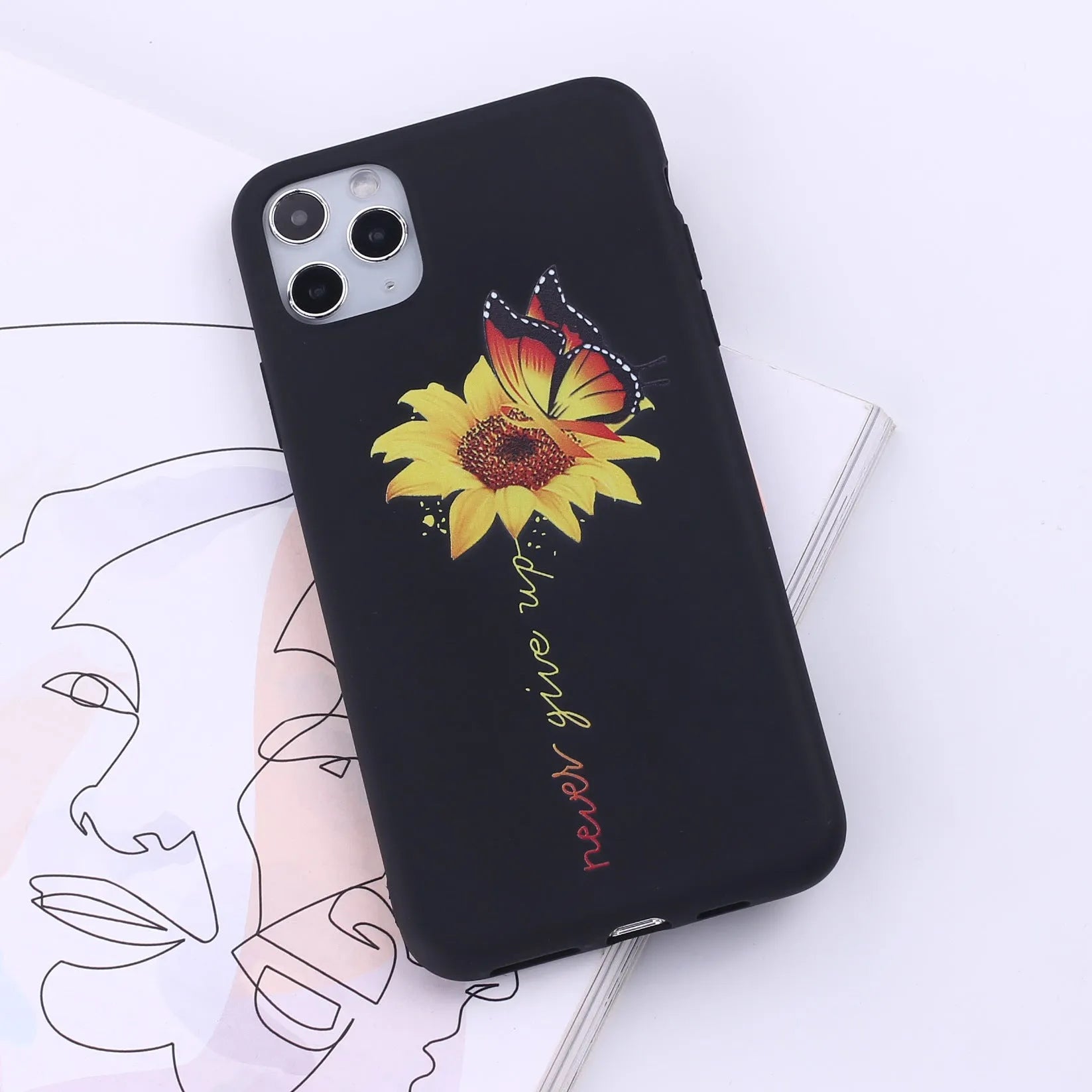 Slim TPU mobile phone case for iPhone on a table, showing one of 14 available colour options.