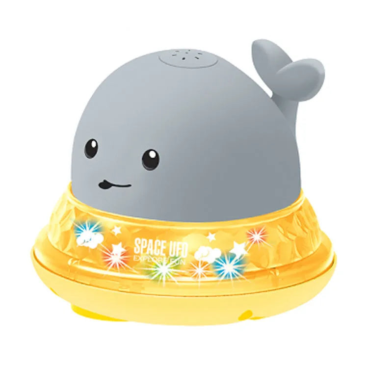 Automatic water spray whale bath toy floating in water with fountain and LED lights