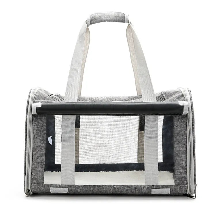 Outdoor portable pet bag in black with transparent panels and mesh sides, folded and shown next to a cat