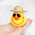 Yellow cartoon Straw Hat Duck car dashboard ornament with matte finish on a car interior.