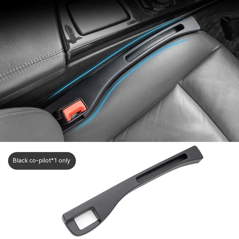Black plastic car seat gap storage box with handle installed between car seats