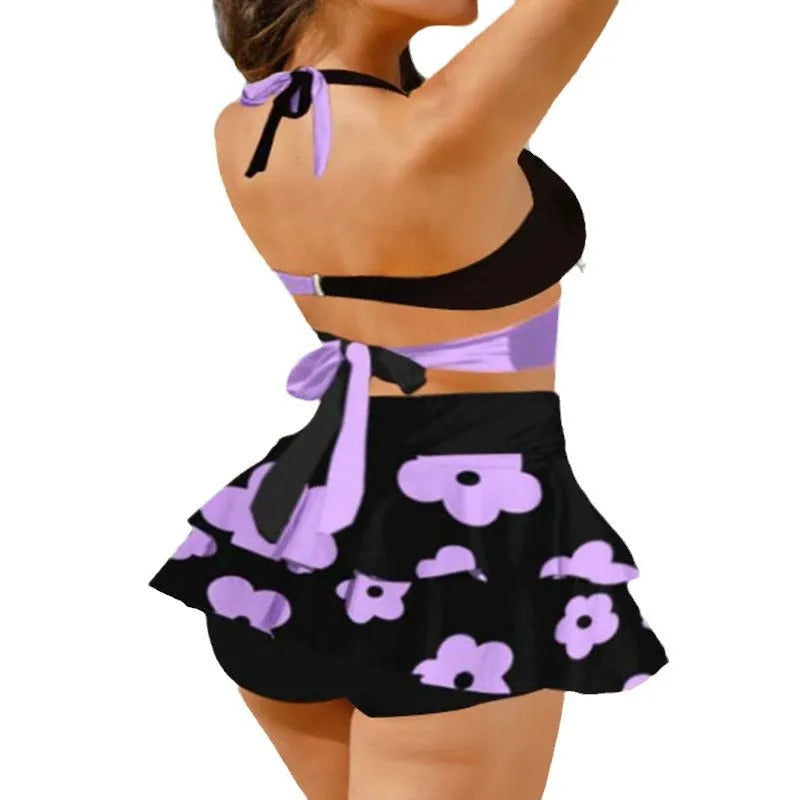 Purple women's lace-up bikini swimsuit set with a matching high-waisted skirt.