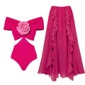 Women's floral patterned hollow out one-piece swimsuit with a separate white skirt laid flat.