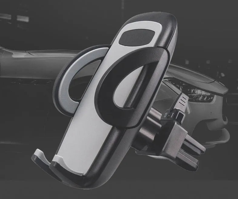 Black plastic car mobile phone holder mounted on air conditioning vent with adjustable arms gripping smartphone