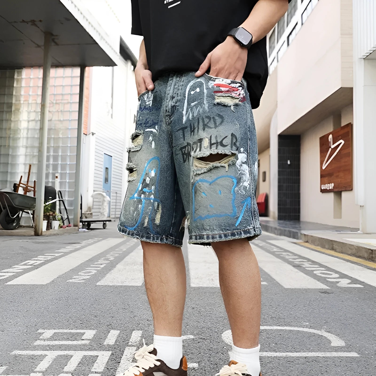 Men's blue ripped denim jeans shorts with graffiti print and straight leg design