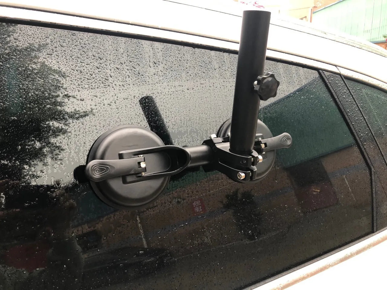 Black off-road car flagpole sucker base with round glass suction cup and rubber disc.