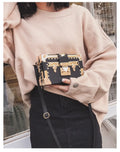 Women's black PU leather hard flap shoulder bag with decorative rivets and hasp closure