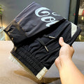 Black men's cropped casual trousers with ankle band made from ultra-thin ice silk cotton fabric.