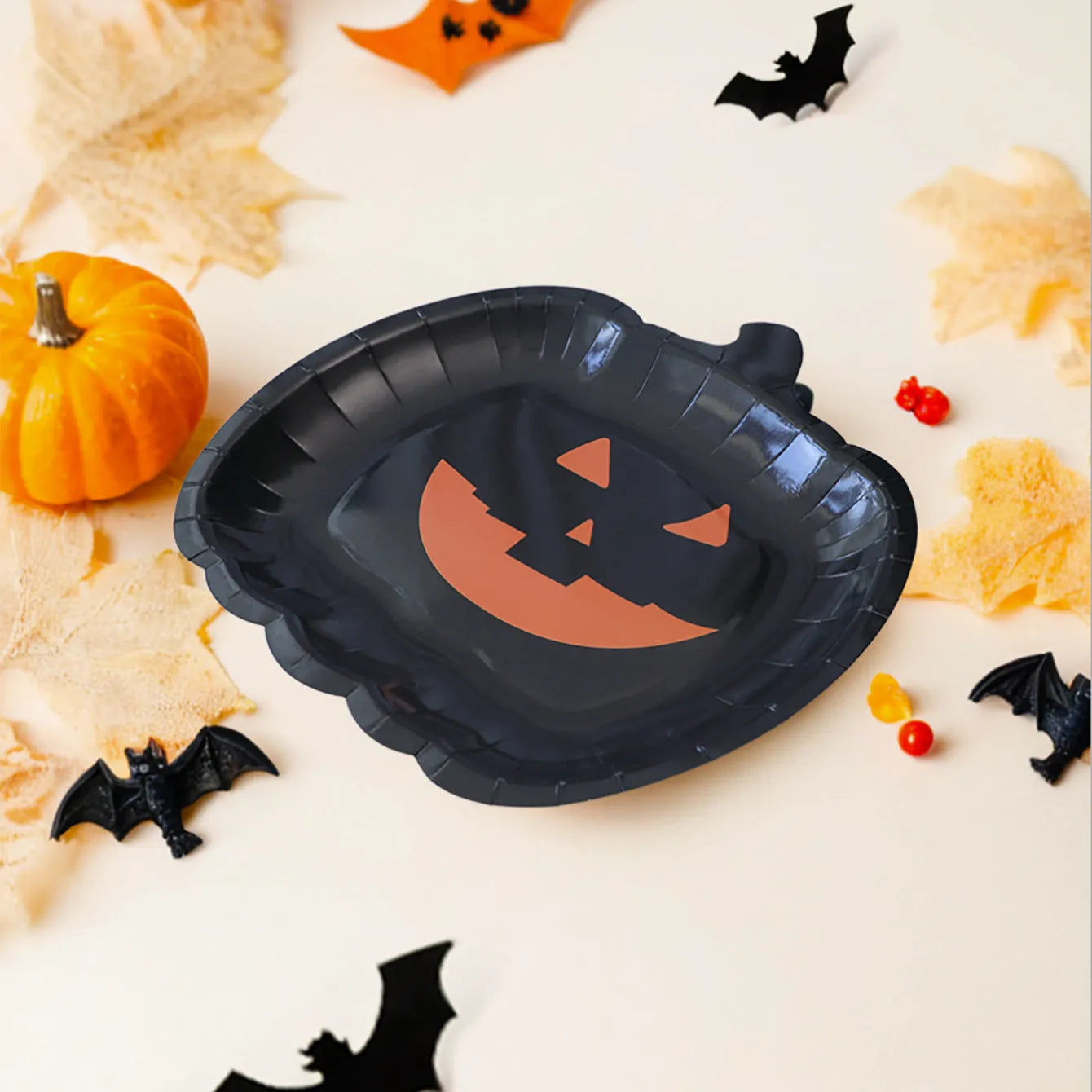 Black pumpkin design disposable paper plates in 9-inch size for Halloween parties