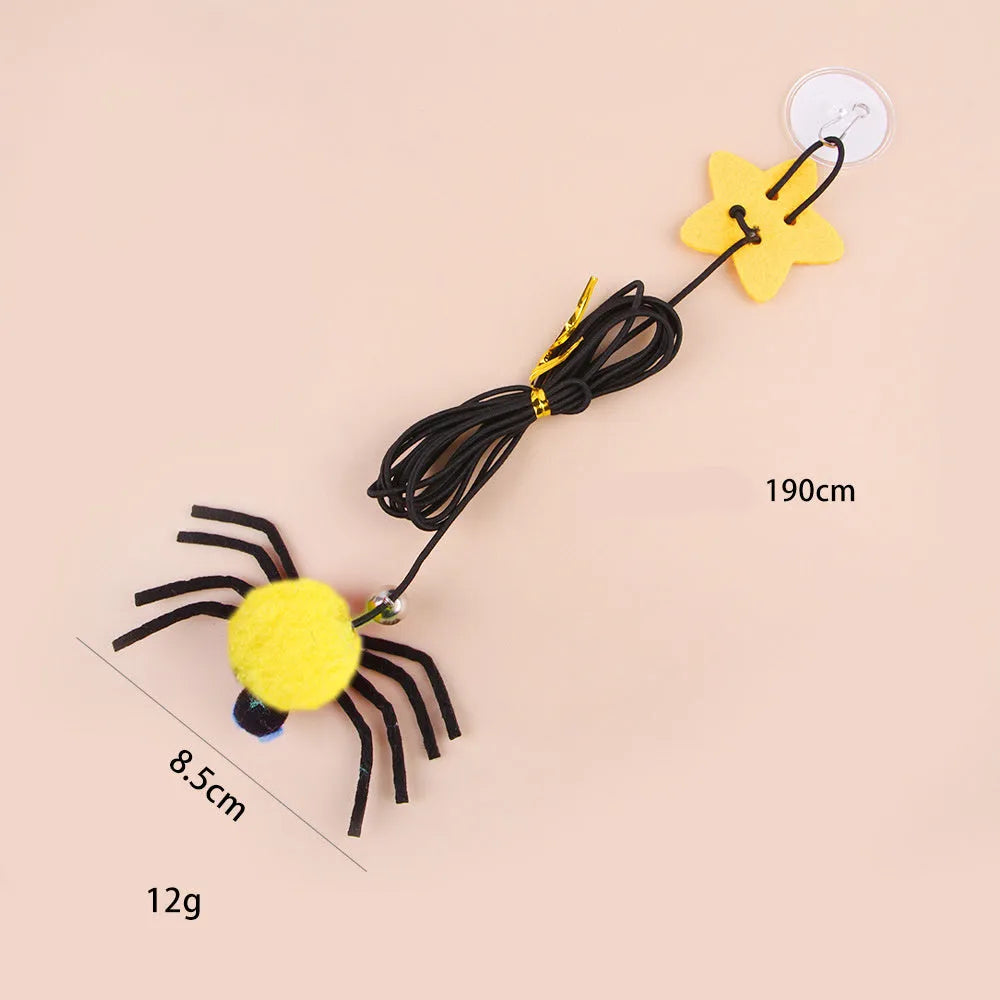 Red and yellow cat hanging door toy with elastic rope, feather, bell, and spider decoration.