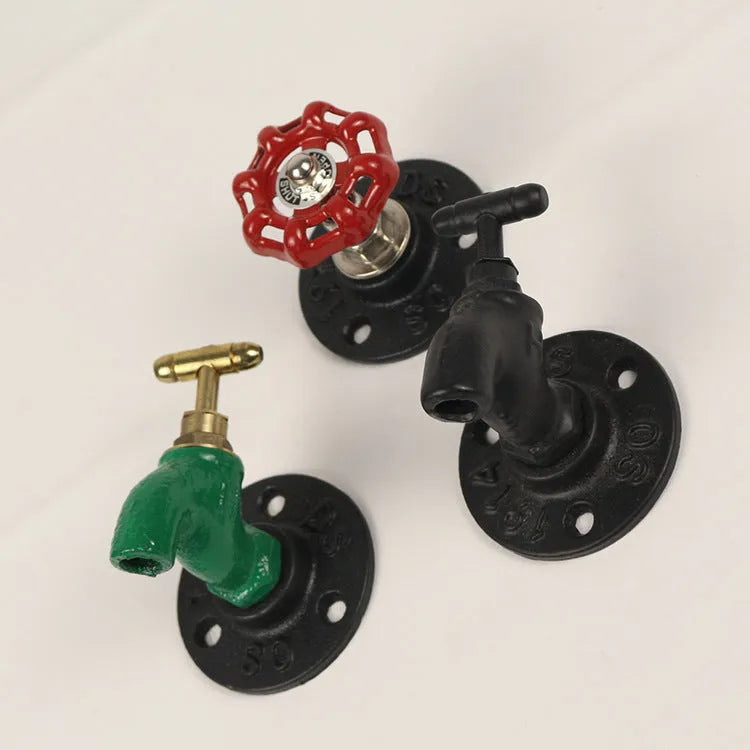Water pipe style polished metal wall hook for hanging towels and clothes in a choice of three colours.