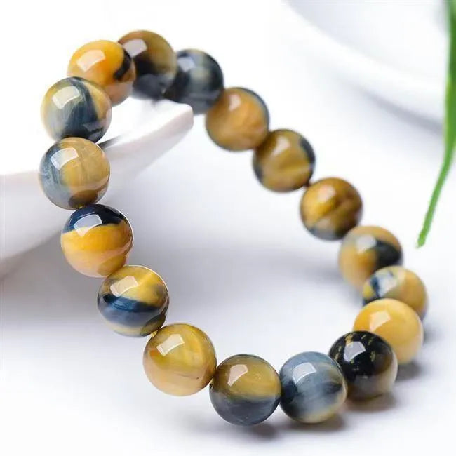 Fantasy Tiger Eye agate beaded bracelet with round beads, shown in unisex design.