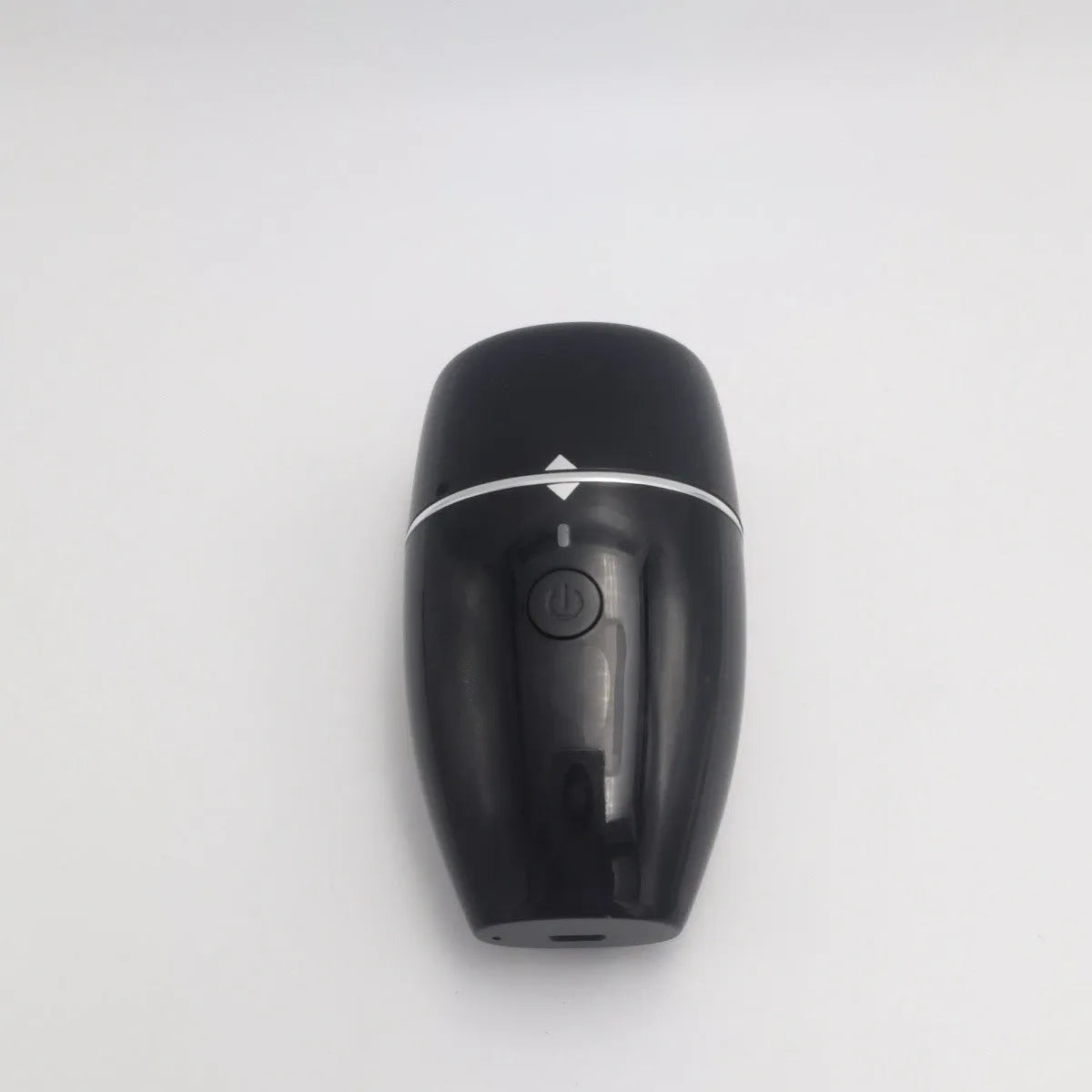 Black and white electric lip plumper device with USB charging cable on a plain background.