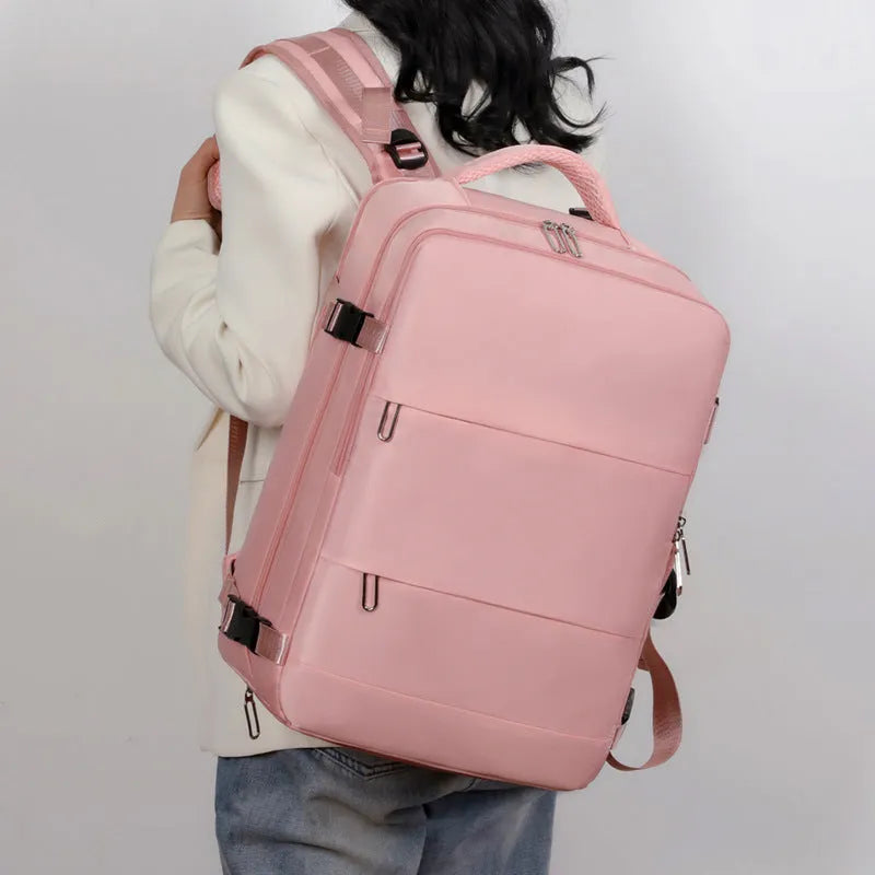 Large purple travel backpack for women with multiple compartments on a grey background.