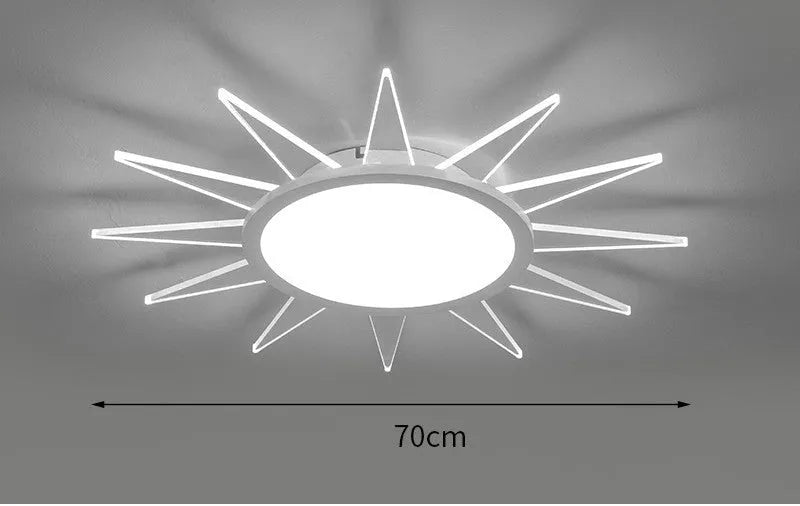 Modern round aluminium LED ceiling lamp with remote control on a white ceiling.
