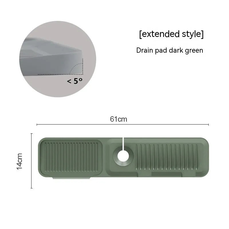 Silicone faucet splash guard pad in sloped design with drain channels on kitchen sink
