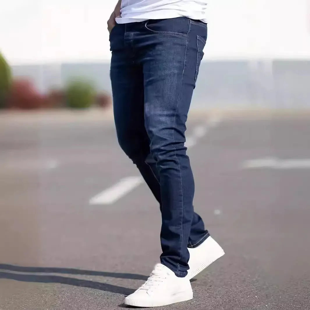 Men's dark blue slim fit casual jeans with mid waist and zipper fly opening