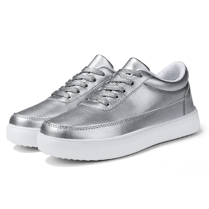 Women's white leather lace-up flat casual shoes on a neutral background.