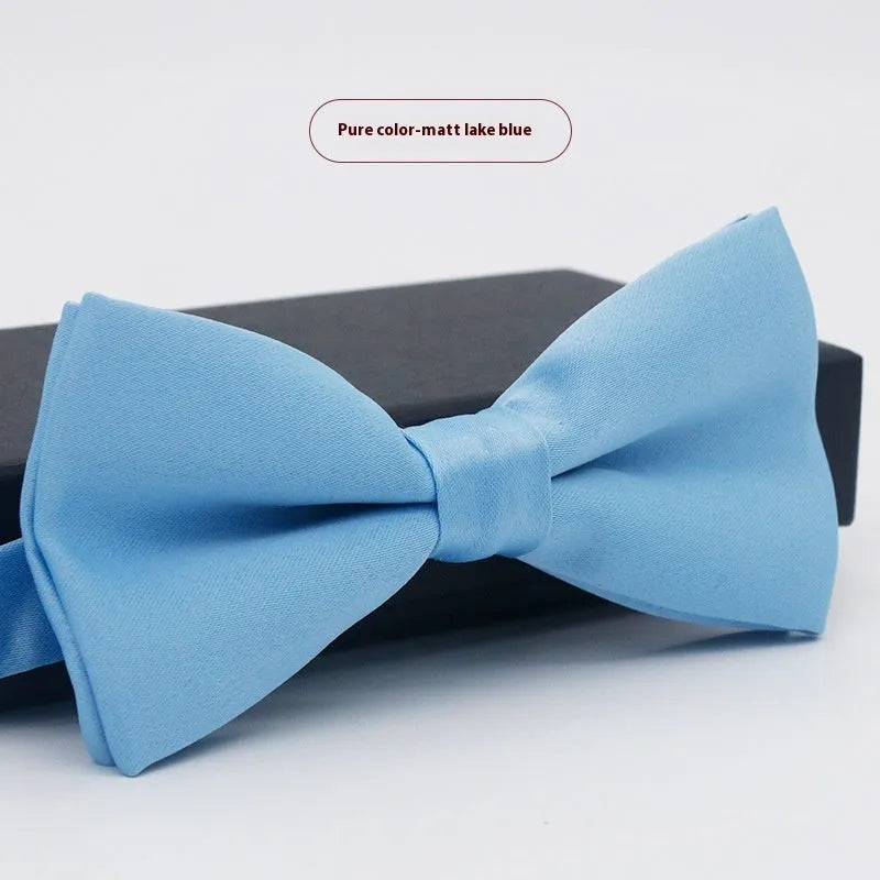 Men's flat head style polyester bow tie in a solid colour, shown with adjustable neck strap.