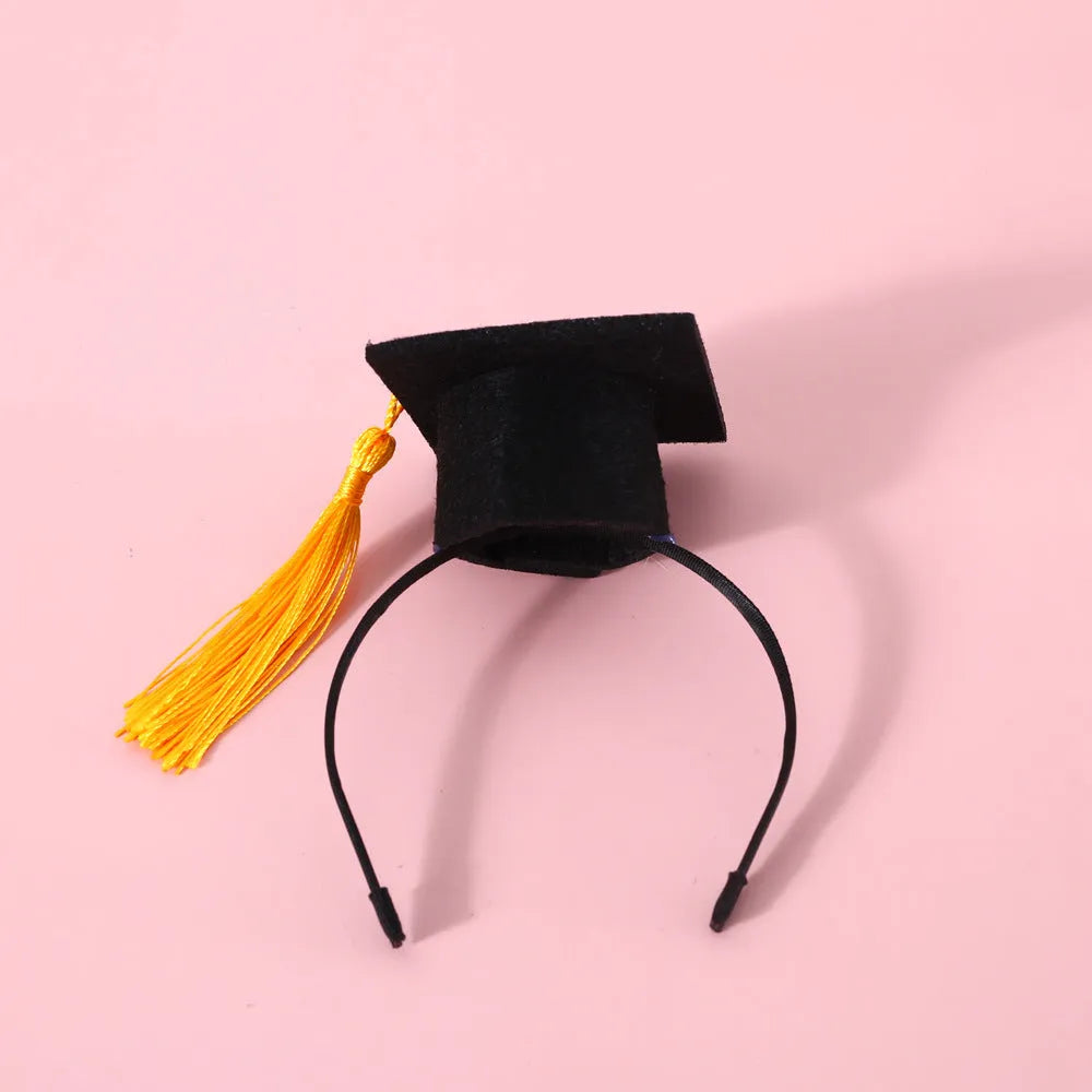 British-style Doctor's Degree elastic hair band and woolen felt bow tie set for a cat or dog, shown in yellow cap colour option.