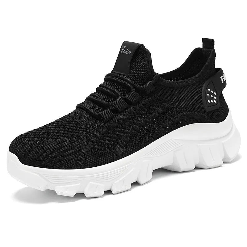 Women's white Flyknit running sneaker with thick PVC sole and lace-up front on a neutral background.