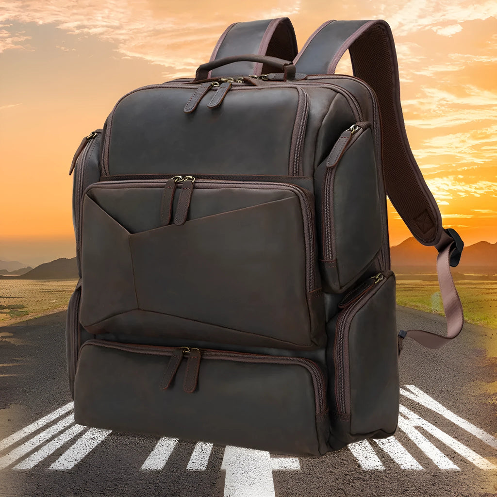 Dark brown retro crazy horse leather men's backpack open to show 17-inch laptop compartment and internal pockets.