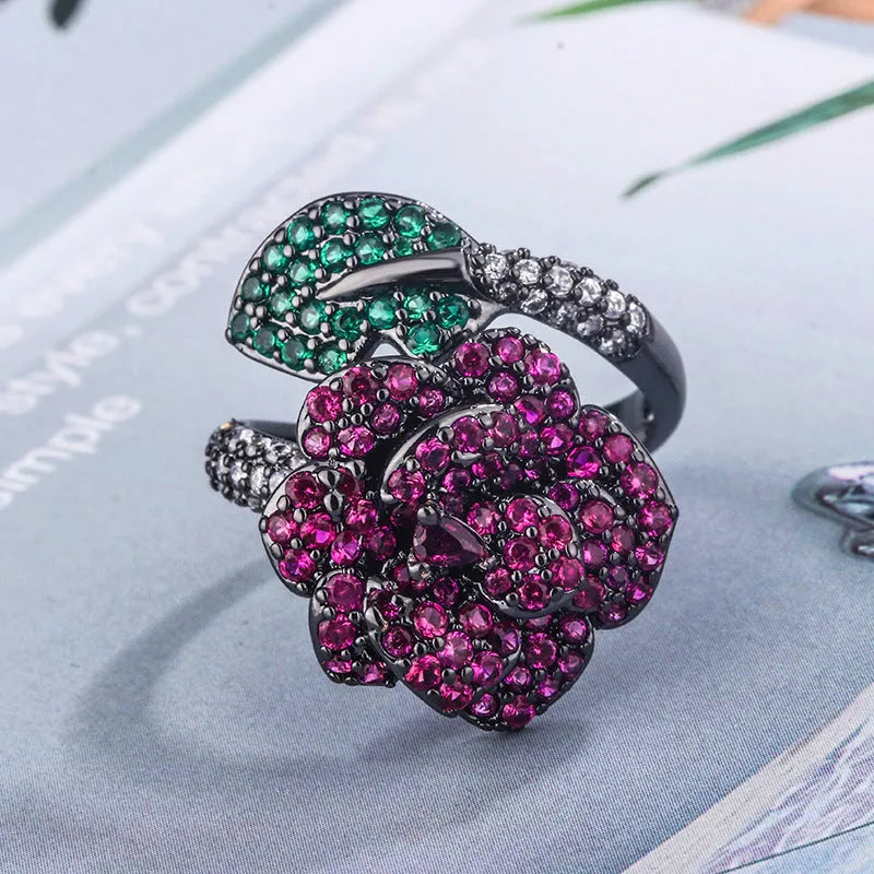 Gold-plated geometric flower ring with red simulated corundum stone on black gold band