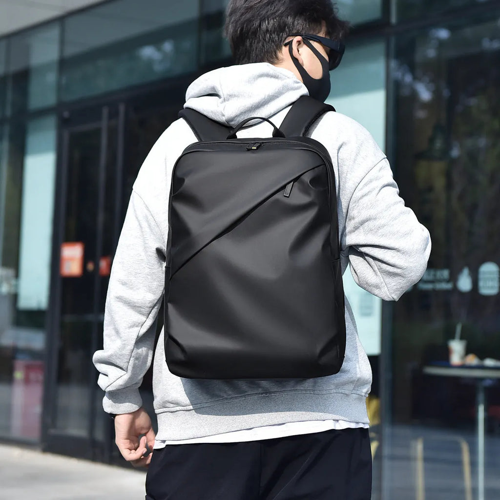 Large capacity waterproof backpack in black blue or grey colours made from PU leather with simple design