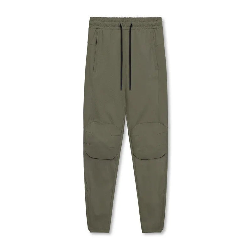 Men's grey loose-fit running pants with ankle ties on a gym floor
