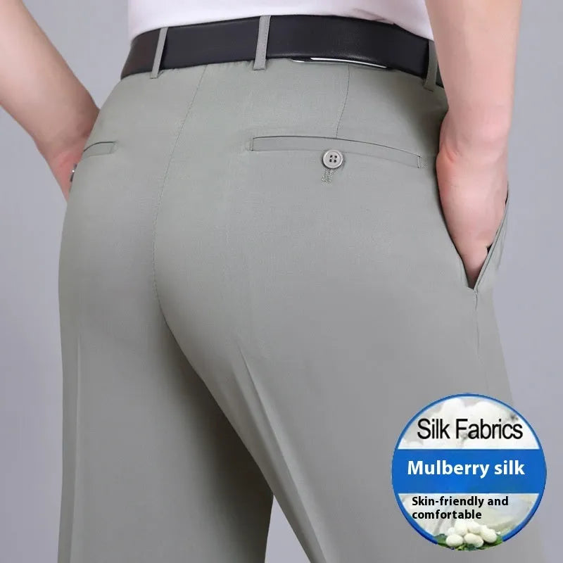 Man wearing dark blue straight-leg suit pants with a high waist, made from a non-ironing mulberry silk blend fabric.