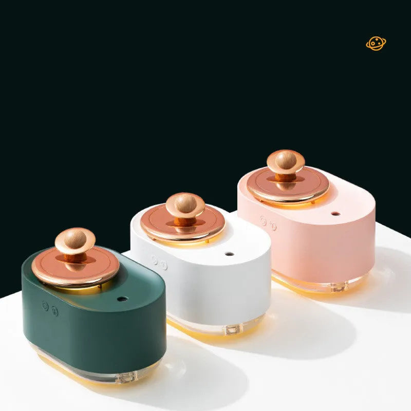 Green rotating planet USB portable humidifier with night light on a wooden desk.