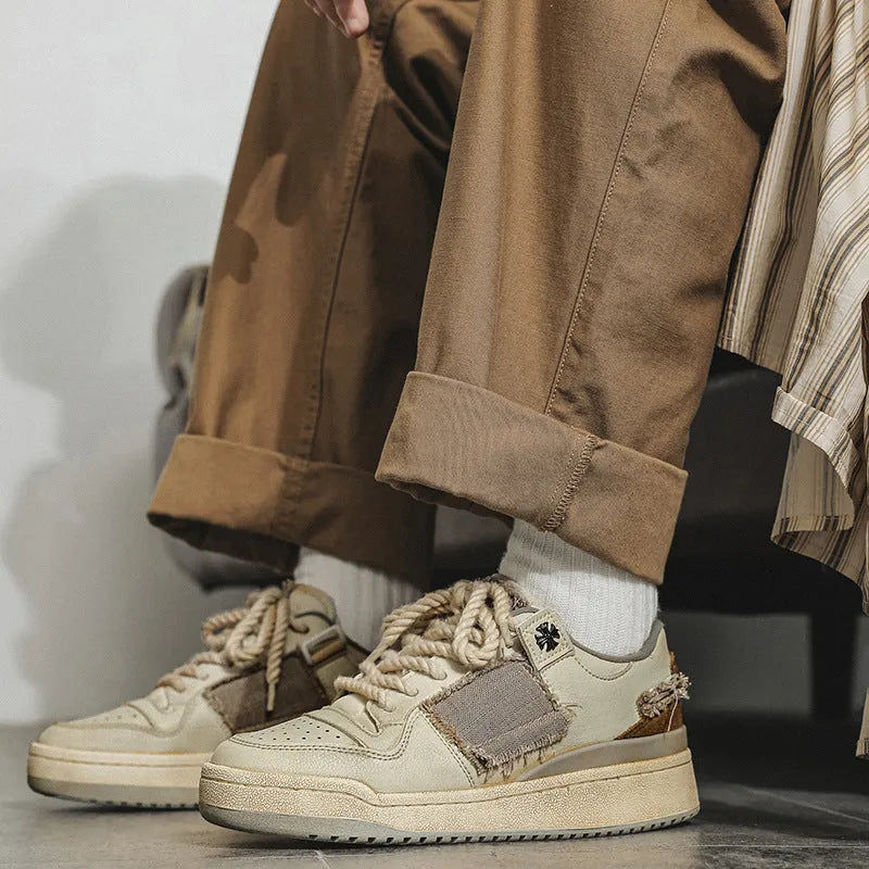 Beige low-top casual skateboard shoes with round toe and front lace-up on a rubber sole.