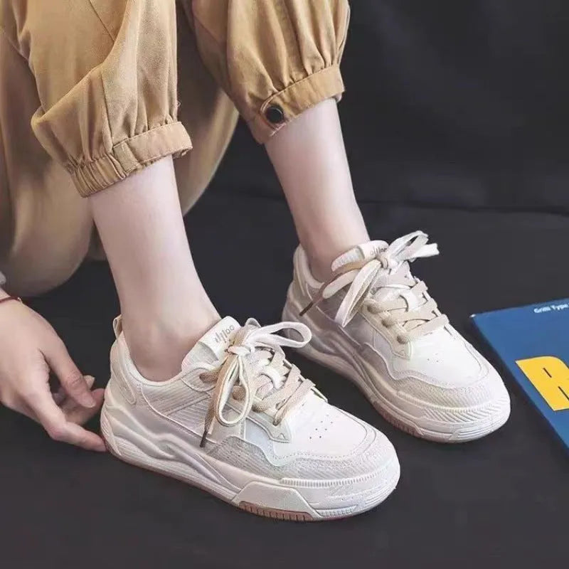 Women's beige and pink low-top rubber sneakers with height-increasing sole on a white background